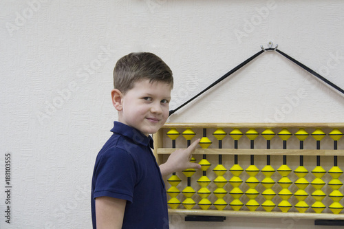 Mental arithmetic school. Boy counts with abacus in `soroban` class. Japanese abacus. Concept of back to school.copy space.