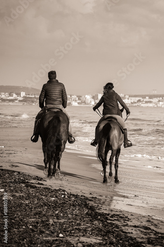 two riders on a wild beach