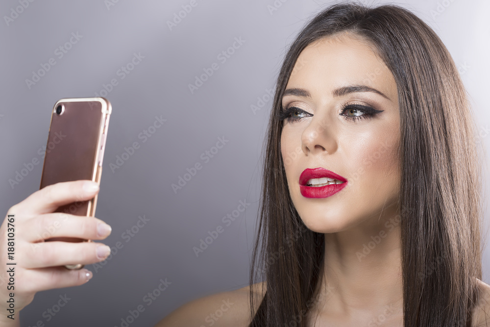 beautiful girl with full make up taking selfie pictures. Valentine's Day.copy space beautiful girl with full make up taking selfie pictures. Valentine's Day.copy space