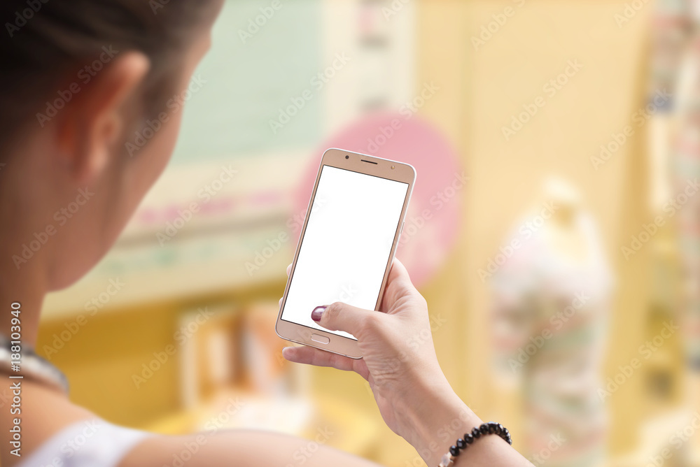 Woman use mobile phone for shopping. Isolated, white screen for text write or app mockup. Clothing store in background.