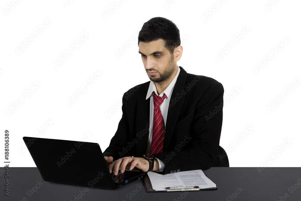 Arabian manager is typing on his laptop Arabian manager is typing on his laptop