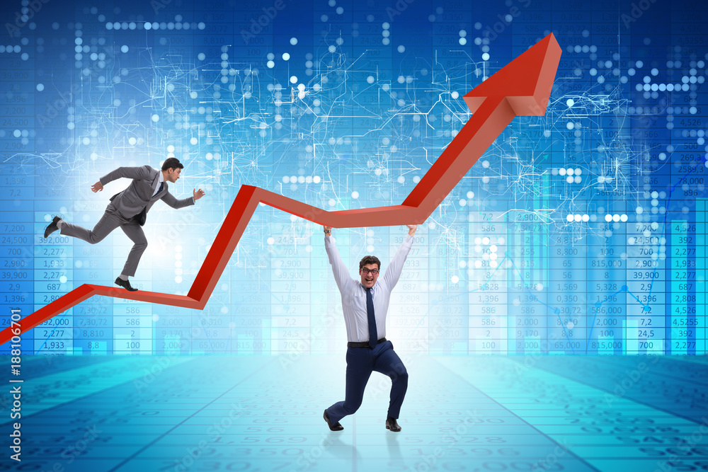 Businessman supporting growtn in economy on chart graph Businessman supporting growtn in economy on chart graph