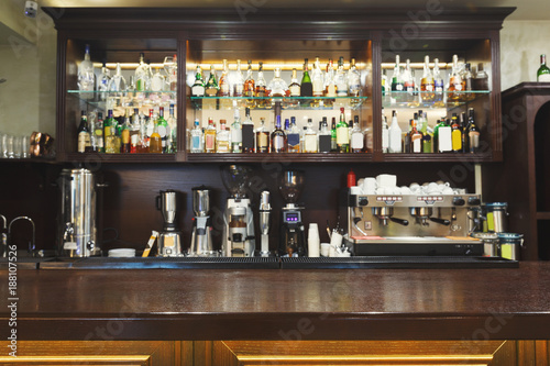 Bar counter with alcohol bottles assortment © Prostock-studio