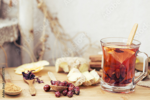 Healthy herbal tea, spiced tea over wood background 