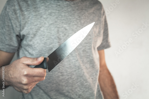Caucasian criminal showing knife.