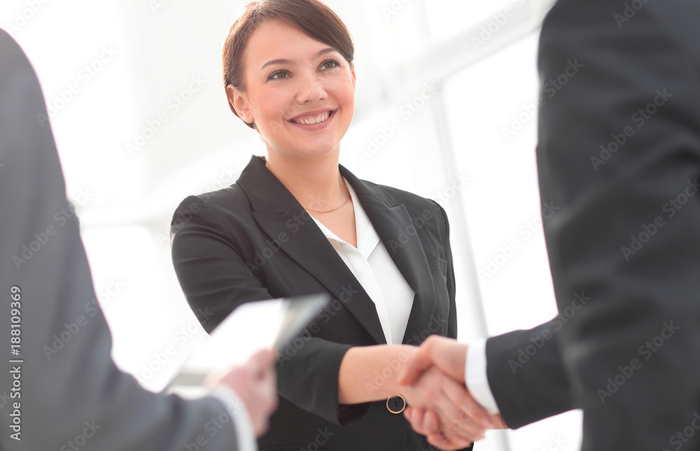 Businesswoman shaking hands with a businssman during a meeting Businesswoman shaking hands with a businssman during a meeting
