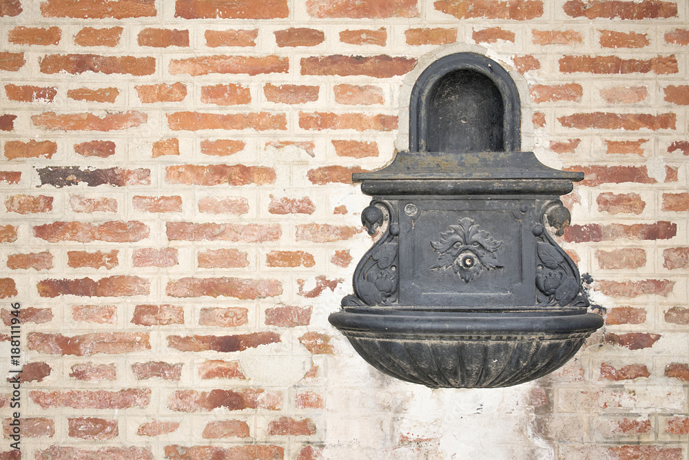 Water fountain on a brick wall. Water fountain on a brick wall.