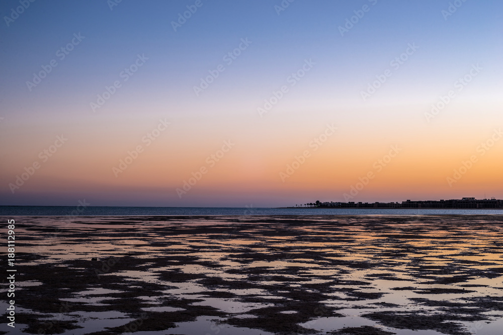 Low tide. Naked coral reef at sunset in the Red Sea
