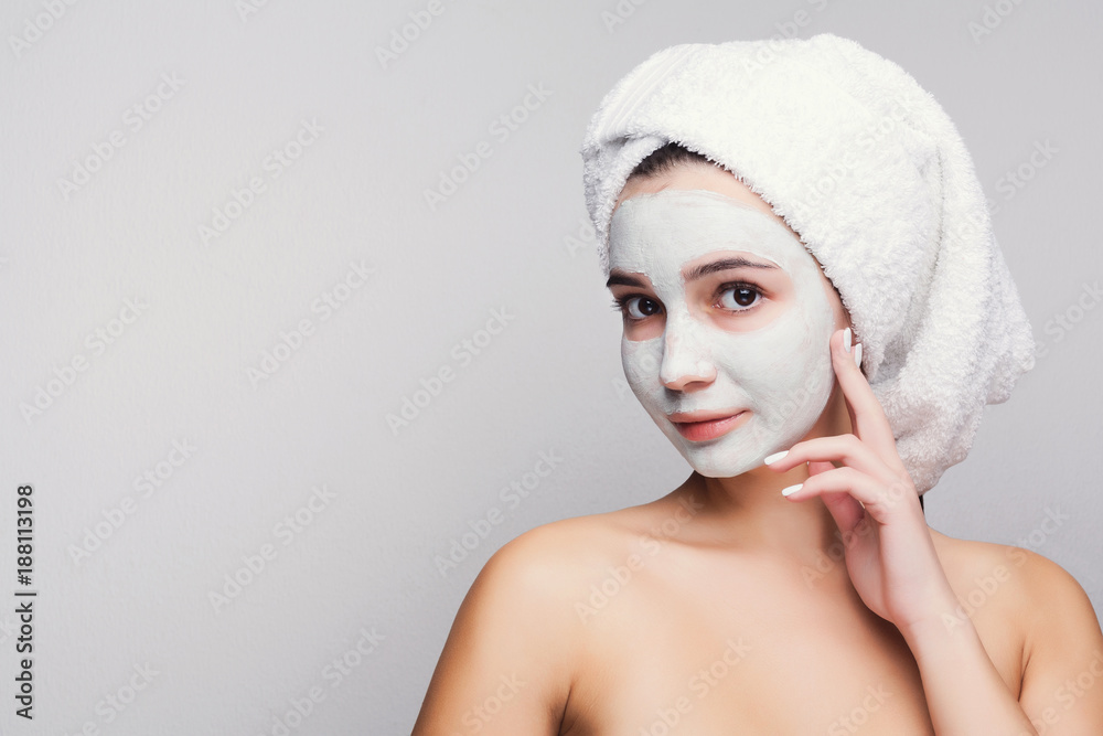 Beautiful girl with applied clay mask at white background Beautiful girl with applied clay mask at white background