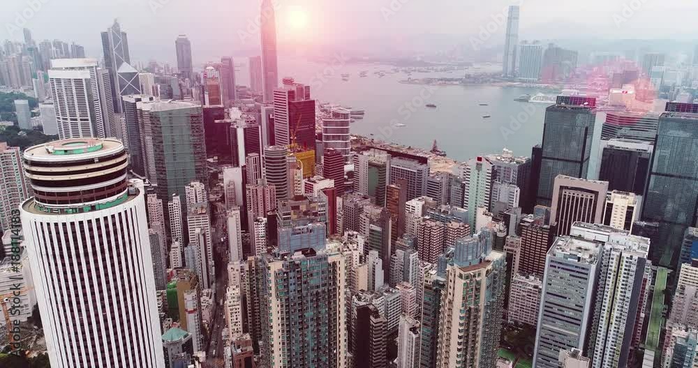 AERIAL. Hong Kong skyline. Hongkong hdr aerial cityscape with sunset sun. Amazing panorama of buildings and sky reflecting in harbour