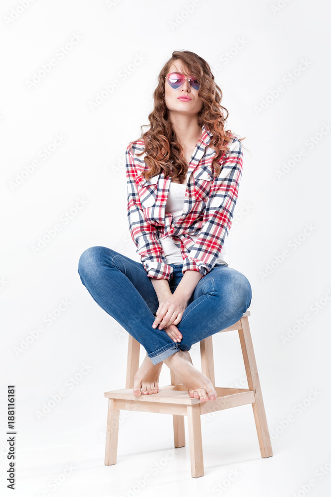 woman in jeans, plaid shirt and sunglasses woman in jeans, plaid shirt and sunglasses