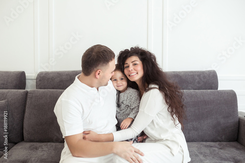 Young happy family, parenthood and people concept. Mother, father and child son at home spending time together