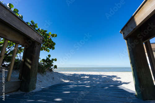 USA  Florida  Perfect white barefoot sand beach with blue sky behind wooden runway