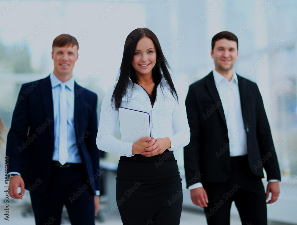 Happy businessman going in front of her team. Happy businessman going in front of her team.