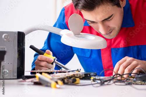 Wallpaper Mural Professional repairman repairing computer in workshop Torontodigital.ca