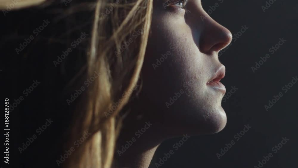 close up shot face young lonely sensual virgin european blue eyes girl room look morning sun light deep breathes in pure smell hair on wind calm atmosphere