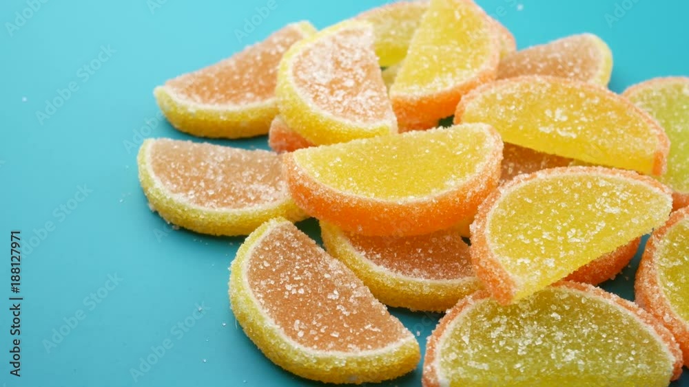 Red and yellow sweets sugar candied fruit jelly on a green background Red and yellow sweets sugar candied fruit jelly on a green background