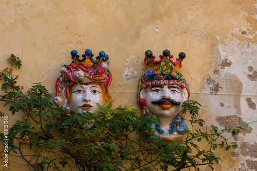 Dark brown ceramic head on the Ragusa Ibla wall