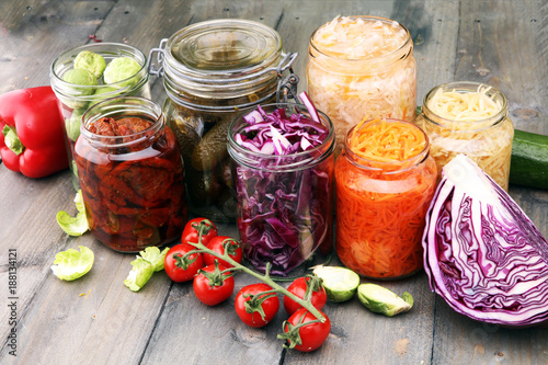 Jars with variety of pickled vegetables. Preserved food photo