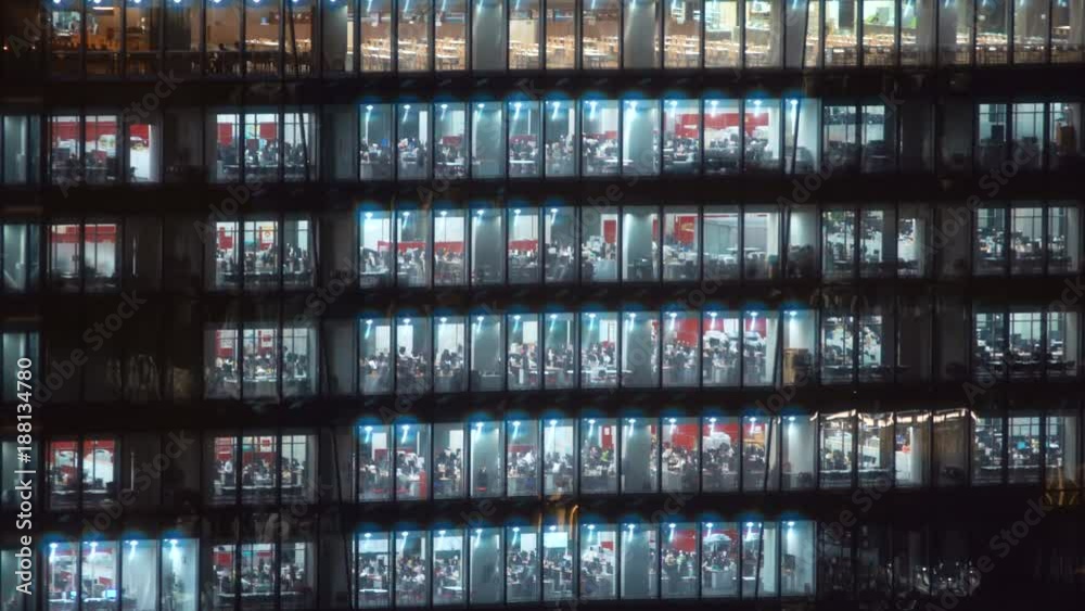 Time-lapse of am office building in Tokyo with workers working inside Time-lapse of am office building in Tokyo with workers working inside