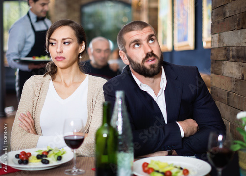 Portrait of upset man and woman in the restaurant on meeting