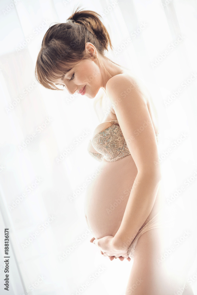 Portrait of a charming pregnant woman stroking a belly Portrait of a charming pregnant woman stroking a belly