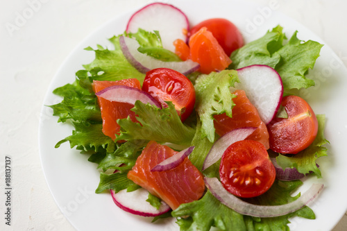 Fresh salad from salmon and vegetables.