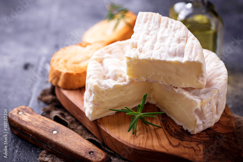 Canvas Print Camembert cheese with rosemary on wooden board