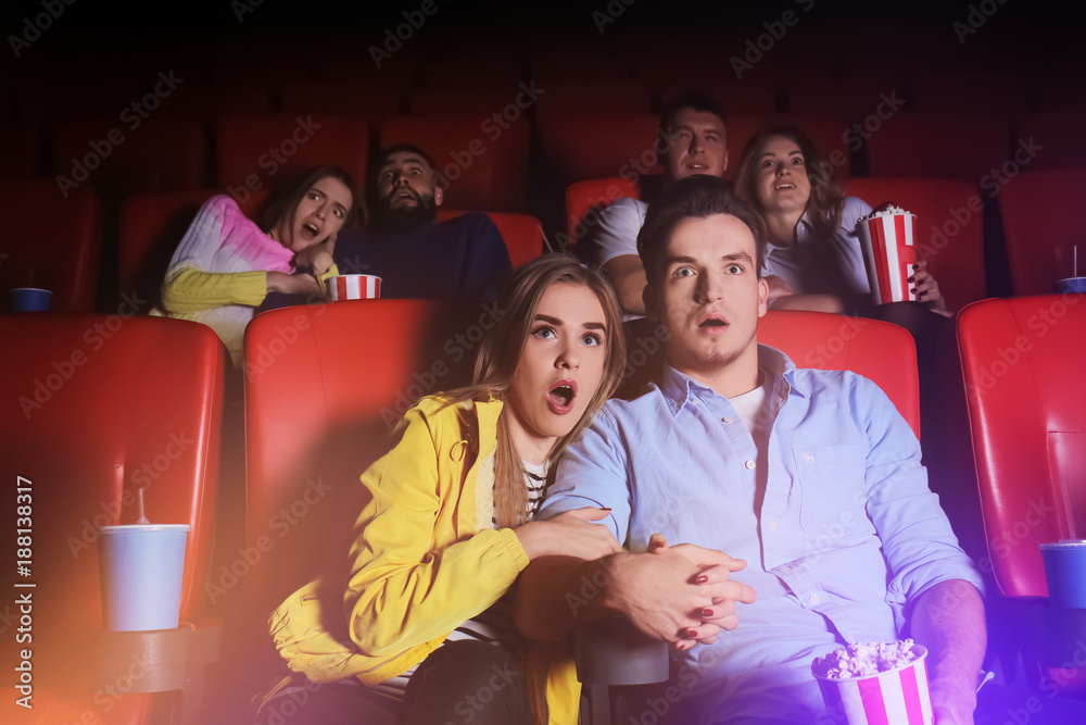 Naklejka premium Young people watching movie in cinema
