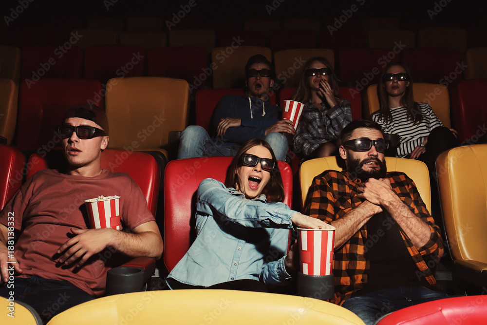 Fototapeta premium Young people watching movie in cinema