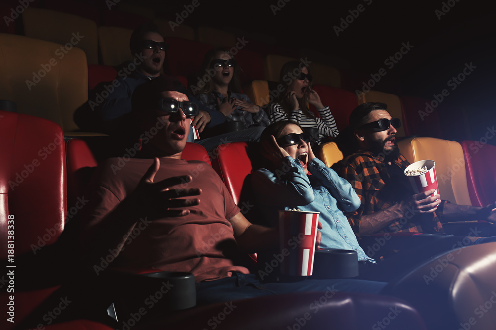 Fototapeta premium Young people watching movie in cinema