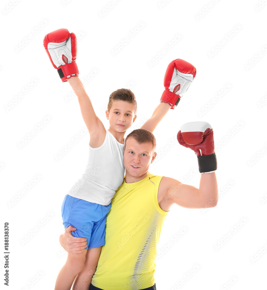 Cute little boy with boxing coach on white background