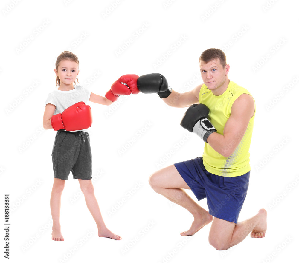 Cute little girl training with boxing coach on white background Cute little girl training with boxing coach on white background