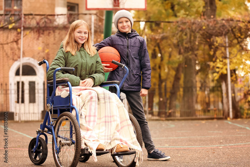 Little girl in wheelchair a...