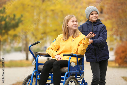 Little girl in wheelchair w...