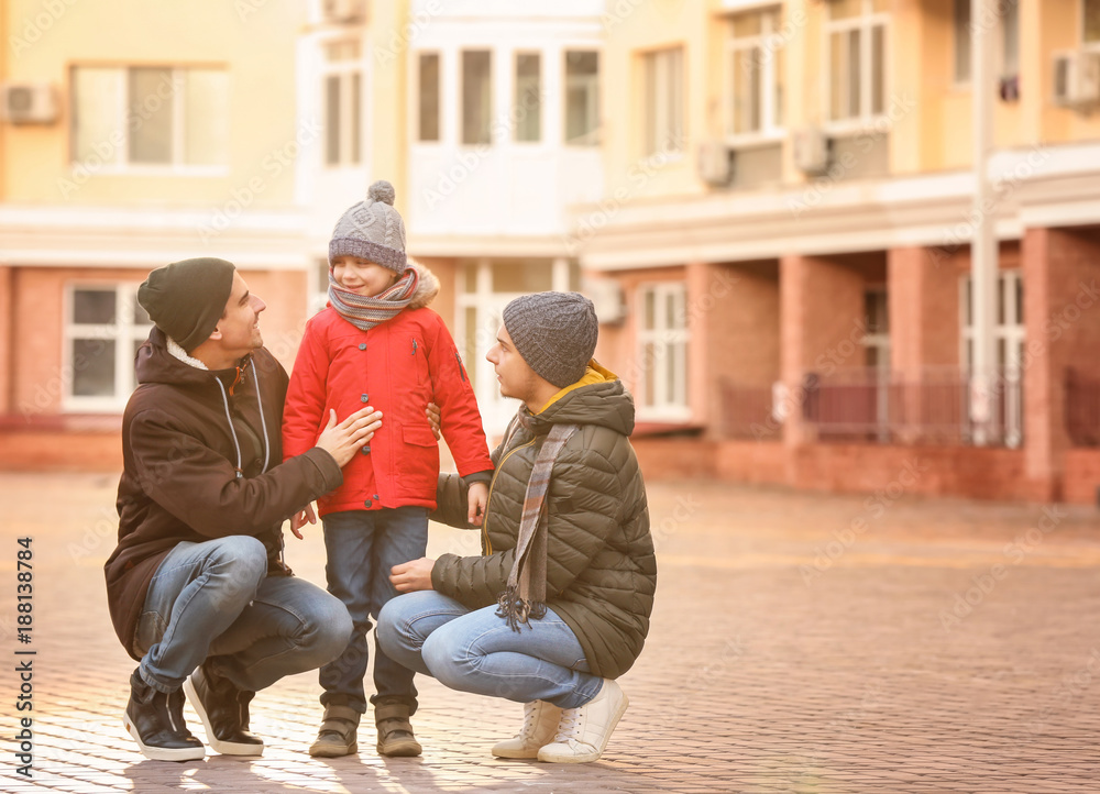 Male gay couple with adopted boy outdoors Male gay couple with adopted boy outdoors