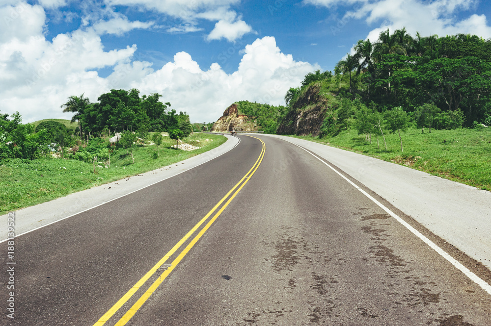 Road crossing the forest with cloudy sky and mountain view. Road crossing the forest with cloudy sky and mountain view.