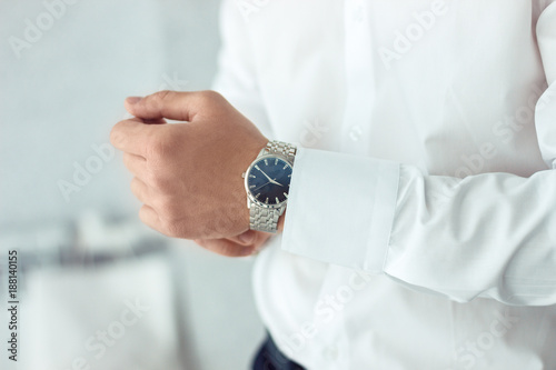 businessman clock clothes, businessman checking time on his wristwatch. men's hand with a watch, watch on a man's hand, putting the clock on the hand, fasten clock watch time, man's style