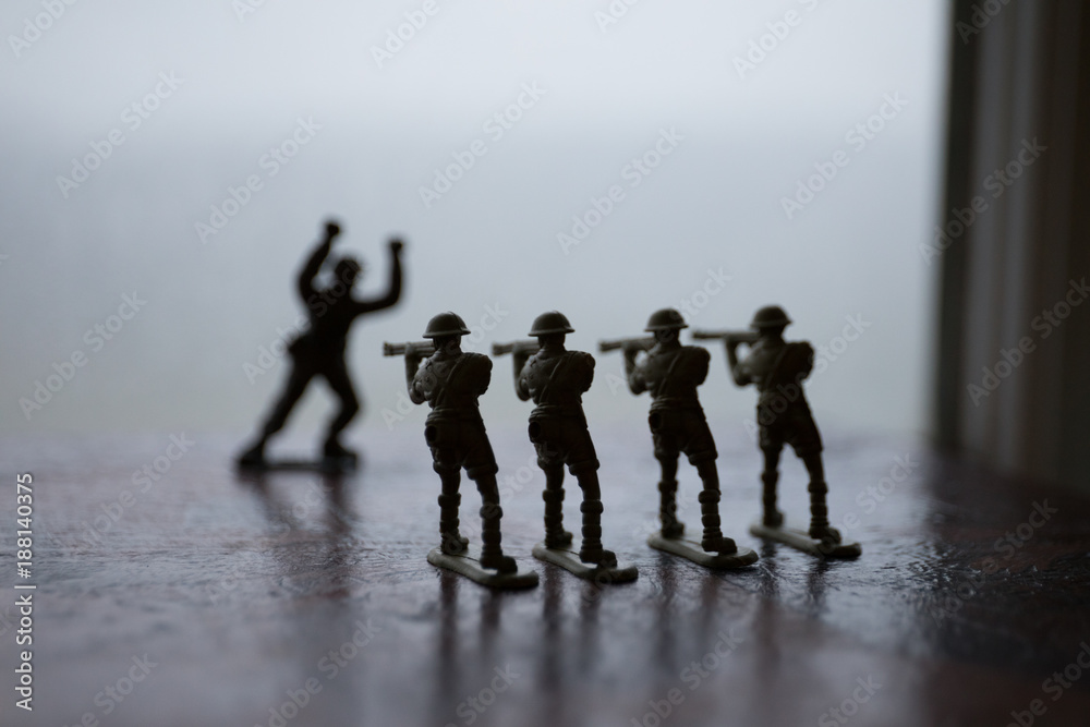 miniature toy soldiers and tank on board. Close up image of toy military at war.