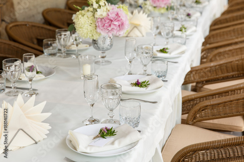 Decoration and table appointments in restaurant or cafe for lunch, dinner or celebrating marriage, wedding and other event and party. Beautiful table setting