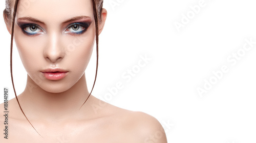 Close up half face portrait of model with glamorous makeup, wet effect on her face and body, high fashion and beauty, creative makeup theme, strobing or highlighting makeup, copy space