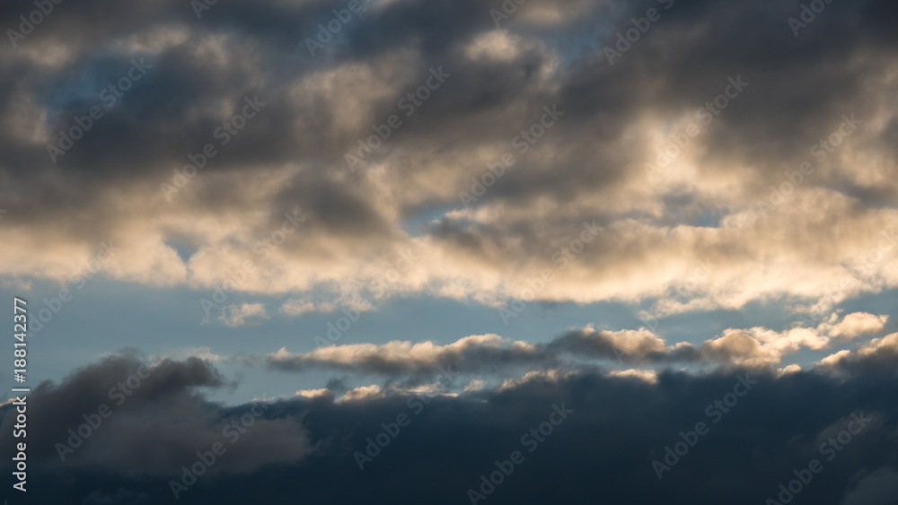 Background with dramatic thunderclouds on blue sky
