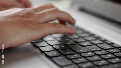 Close up hand worker typing on laptop keyboard 