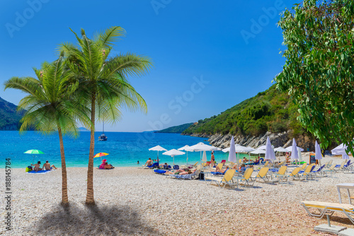 Fototapeta Naklejka Na Ścianę i Meble -  Beautiful summer holiday scene of Mikros Poros Gialos beach with people enjoying vacation in Lefkada island, Greece
