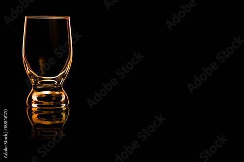 An empty glass of water with fire reflection.
