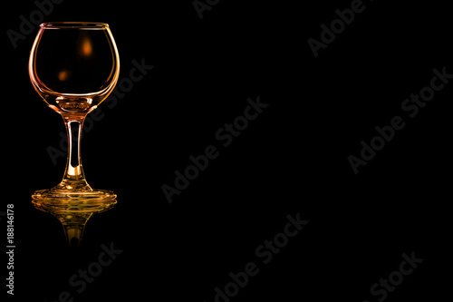 Empty glass of liqueur or cocktail sour with fire reflection.
