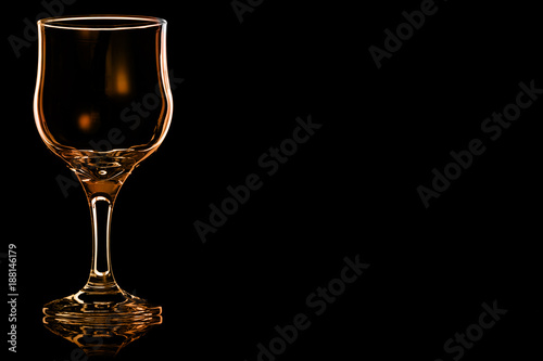 Empty glass of red wine with fire reflection.