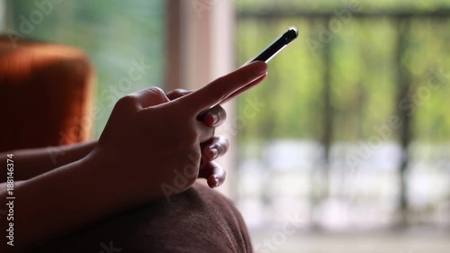 Close up woman hands using and typing text message on smart phone device at home 