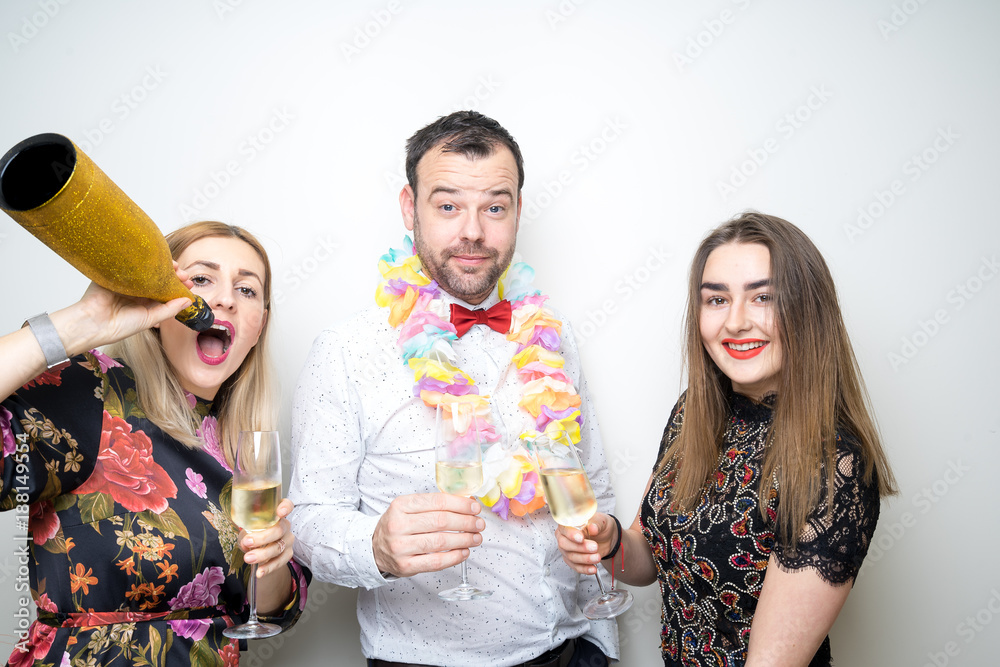 three people funny props pose photo booth happy fun bottle