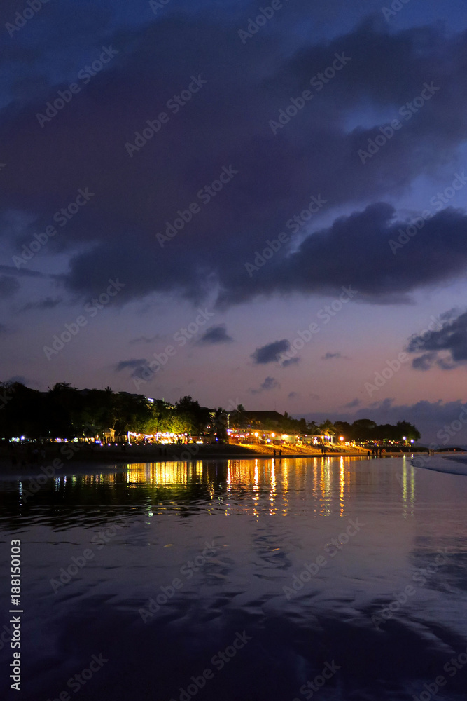 Night lights reflection after sunset at Kuta beach, Bali, Indonesia Night lights reflection after sunset at Kuta beach, Bali, Indonesia